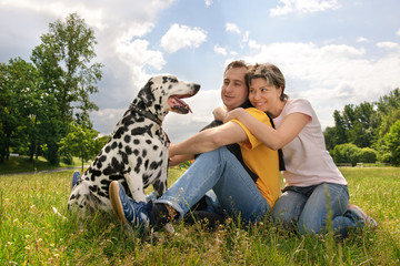 loving couple with a Dalmatian outdoors