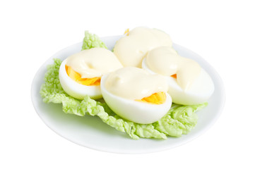 Eggs with mayonnaise on green lettuce leaf