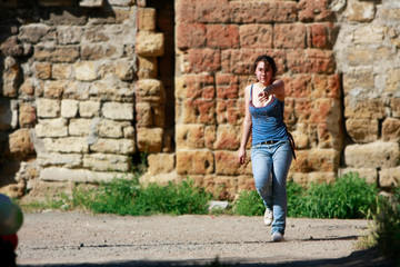 Fototapeta na wymiar attractive teen girl walking on grunge background