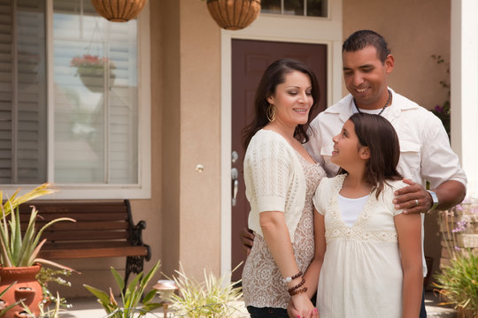 Hispanic Family In Front Of Their Home