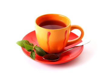 Cup of green tea on the saucer with mint