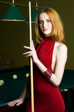 Woman in red with cue