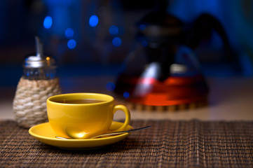 Tea in yellow cup on table