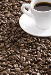 Coffee cup and grain on white background