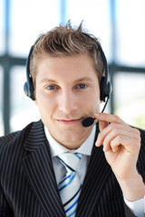 Handsome young businessman with a headset on