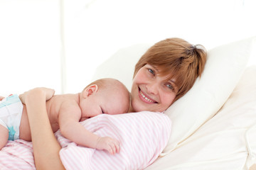 Obraz na płótnie Canvas Happy mother embracing her newborn baby
