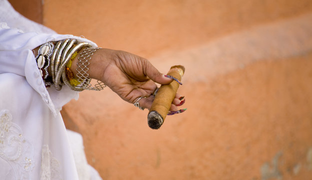 woman's hand holding a cigar