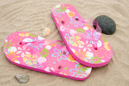 pink slippers on beach
