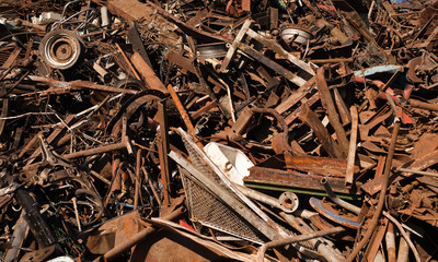 Rusted discarded pieces of metal in junkyard