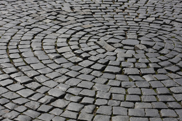 Old medieval granite cobble road background texture