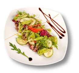 A plate of pork with vegetables. File includes clipping path for