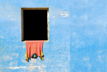 blue wall with shirt hanging to dry in baracoa, cuba