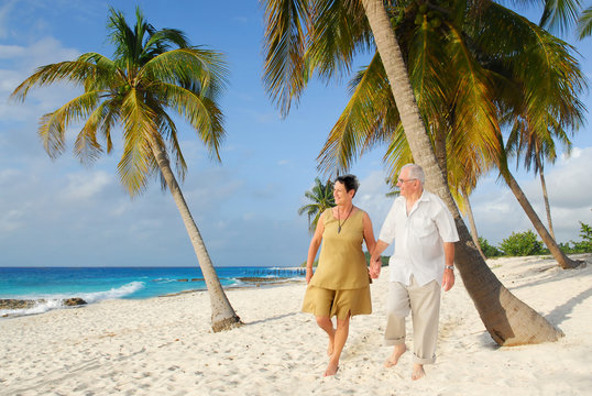 happy european seniors on tropical beach in cuba
