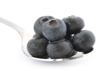 Spoon with fresh blueberries