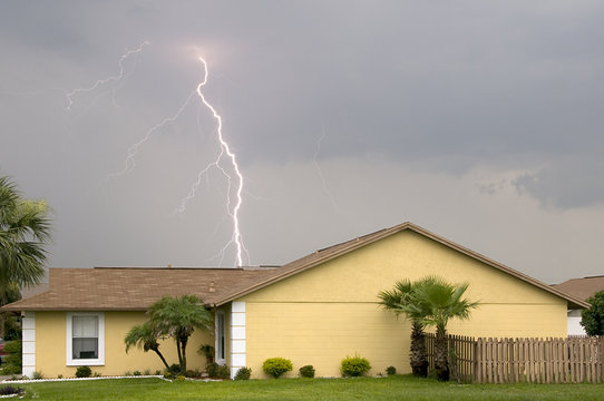 Daytime lightning strike near homes during afternoon storm