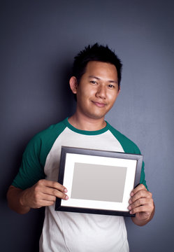 Man Holding Picture Frame