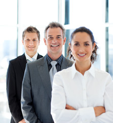 Mature businessman smiling at the camera in a line