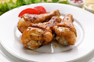 Roasted chicken legs with chips and vegetables
