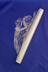 A partially unrolled roll of plastic wrap/cling film