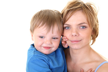 young little son embracing his pretty young mother