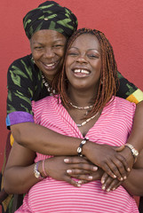 mom hugging pregnant daughter