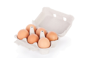 Half dozen brown chicken eggs in box  isolated on white