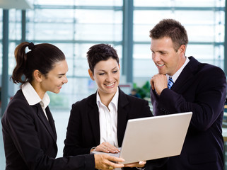 Businesspeople using laptop