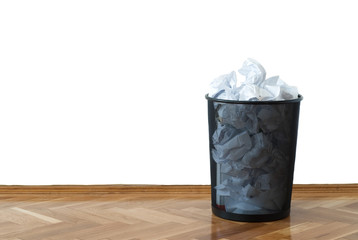 Full wastepaper basket with copy space