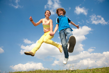 Girl and boy jumping. Soft focus. Focus on eyes.
