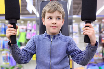 boy in shop on  sports exerciser