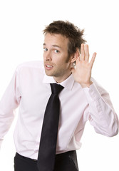 Young business man cupping hand behind ear