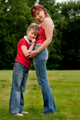 Happy mother and daugther in red