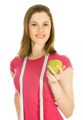 Beautiful girl holding an apple and a measure tape; isolated on