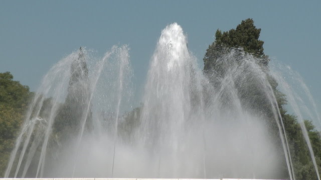 Water fountain splashing with sky on background