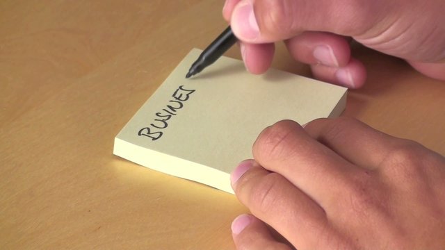 mann notiert sich "businessplan" auf einen zettel