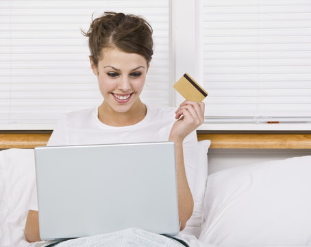 Woman With Credit Card and Laptop