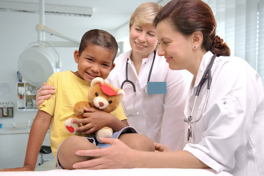 female doctors examining little child boy