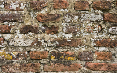 Part of 300 years old brick stone wall in close view