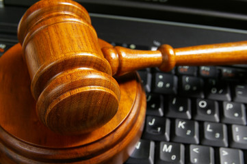 closeup of judges gavel on laptop computer