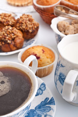 cup of coffee with muffins and cakes