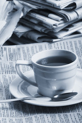 Cup  coffee on a morning paper business news