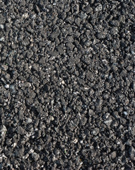 tar and stones of asphalt road