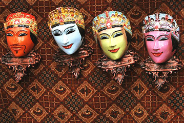 Wooden mask on hand painting cloth background
