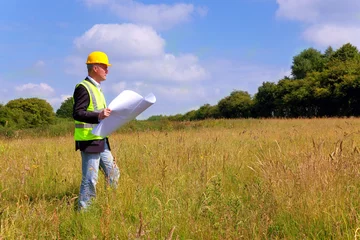 Tuinposter Architect surveying a new building plot © RTimages