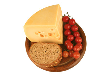 big chunk of yellow cheese with tomatoes and bread