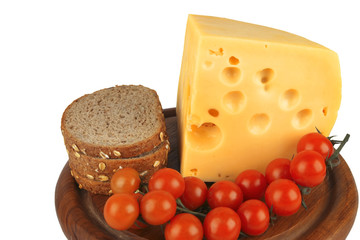 big chunk of yellow cheese with tomatoes and bread