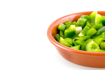 Stone dish with green paprika on white background
