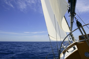 Sailboat sailing blue sea on sunny summer day
