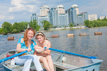Fototapeta na wymiar Mom and Daughter relax in boat