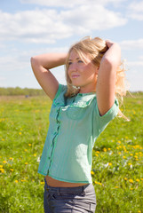 Young  Sexy  blonde   on background of the green meadow